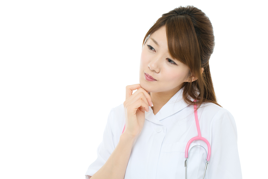 Beautiful asian nurse on white background